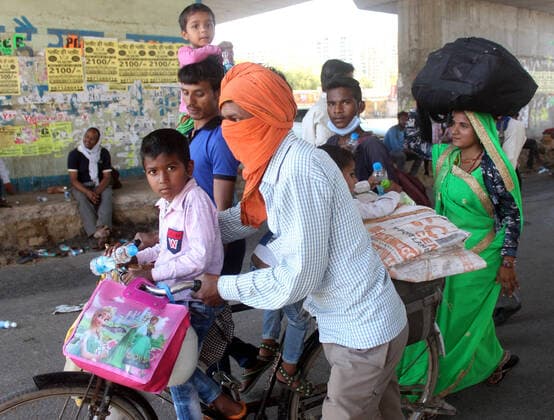 GURUGRAM, INDIA - MARCH 28: Migrant workers going back to their towns and villages, on day 4 of the nationwide lockdown to check the spread of coronavirus, at Delhi-Gurugram expressway near Delhi- Gurugram border, on March 28, 2020 in Gurugram, India. (Photo by Yogendra Kumar Hindustan Times ) Coronavirus Update: Amid Lockdown, A Sea Of Migrants In Delhi-NCR Try To Find Their Way Back Home
