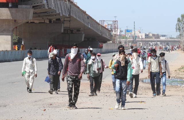 GURUGRAM, INDIA - MARCH 28: Migrant workers going back to their towns and villages, on day 4 of the nationwide lockdown to check the spread of coronavirus, at Delhi-Gurugram expressway near Delhi- Gurugram border, on March 28, 2020 in Gurugram, India. (Photo by Yogendra Kumar Hindustan Times ) Coronavirus Update: Amid Lockdown, A Sea Of Migrants In Delhi-NCR Try To Find Their Way Back Home