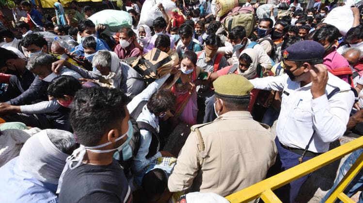 NEW DELHI, INDIA - MARCH 28: Migrants workers seen in large numbers as they try to Kaushambi Roadways Bus Stand on Day 4 of the 21 day nationwide lockdown -- to check the spread of coronavirus, at Delhi UP border (opposite Anand Vihar Bus Stand, on March 28, 2020 in New Delhi, India. (Photo by Ajay Aggarwal Hindustan Times ) Coronavirus Update: Amid Lockdown, A Sea Of Migrants In Delhi-NCR Try To Find Their Way Back Home