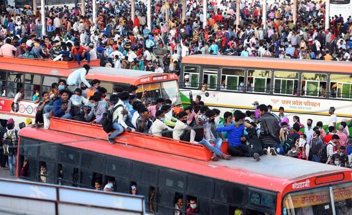 NEW DELHI, INDIA - MARCH 28: A wave of migrant workers seen at Anand Vihar Bus Terminus near the Delhi - UP border following Uttar Pradesh government?s call to arrange buses for the workers returning to their native state, on Day 4 of the 21 day nationwide lockdown -- to check the spread of coronavirus, on March 28, 2020 in New Delhi, India. (Photo by Raj K Raj Hindustan Times ) Coronavirus Update: Amid Lockdown, A Sea Of Migrants In Delhi-NCR Try To Find Their Way Back Home
