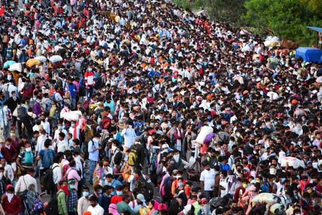 NEW DELHI, INDIA - MARCH 28: A wave of migrant workers seen at Anand Vihar Bus Terminus near the Delhi - UP border following Uttar Pradesh government?s call to arrange buses for the workers returning to their native state, on Day 4 of the 21 day nationwide lockdown -- to check the spread of coronavirus, on March 28, 2020 in New Delhi, India. (Photo by Raj K Raj Hindustan Times ) Coronavirus Update: Amid Lockdown, A Sea Of Migrants In Delhi-NCR Try To Find Their Way Back Home