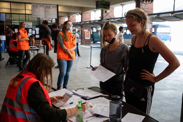 March 27, 2020, Kathmandu, Nepal: A staff from German embassy checks passenger s passports for their chartered flight back home at Tribhuvan International Airport in Kathmandu..A rescue flight was arranged by the German government to pick up tourists who had been stranded in Nepal due to the government-imposed lock-down amid concerns over the spread of Coronavirus. Kathmandu Nepal - ZUMA Pla 20200327_mda_s197_269 Copyright: xPrabinxRanabhatx