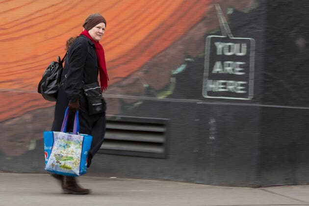 March 28, 2020, Seattle, Washington, U.S: A woman walks with shopping bags in hand in Seattleâ€⠢s Capitol Hill neighborhood on Saturday, March 28, 2020. Under governor Jay Insleeâ€⠢s statewide stay home proclamation, now extended until April 6, people are able to leave their homes only for essential activities including grocery shopping, exercise and caring for a family member, friend or pet. Seattle U.S. - ZUMAg235 20200328_zap_g235_003 Copyright: xPaulxChristianxGordonx