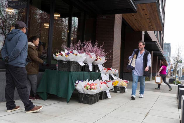 March 28, 2020, Seattle, Washington, U.S: A pop up shop offers fresh flowers in Seattleâ€⠢s Capitol Hill neighborhood on Saturday, March 28, 2020. In an effort to assist local businesses during the temporary closure, Savor Seattle is offering customer pickup in various locations around the city of fresh produce and flowers from Pike Place Market. Under governor Jay Insleeâ€⠢s statewide stay home proclamation, now extended until April 6, people are able to leave their homes only for essential activities including grocery shopping, exercise and caring for a family member, friend or pet. Seattle U.S. - ZUMAg235 20200328_zap_g235_006 Copyright: xPaulxChristianxGordonx