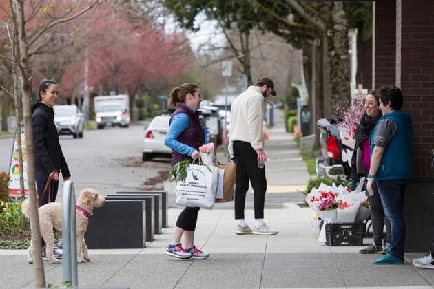 March 28, 2020, Seattle, Washington, U.S: JENNIE DULAS (second from right), managing director for Savor Seattle, greets customers at a pop up shop in Seattleâ€⠢s Capitol Hill neighborhood on Saturday, March 28, 2020. In an effort to assist local businesses during the temporary closure, Savor Seattle is offering customer pickup in various locations around the city of fresh produce and flowers from Pike Place Market. Under governor Jay Insleeâ€⠢s statewide stay home proclamation, now extended until April 6, people are able to leave their homes only for essential activities including grocery shopping, exercise and caring for a family member, friend or pet. Seattle U.S. - ZUMAg235 20200328_zap_g235_008 Copyright: xPaulxChristianxGordonx