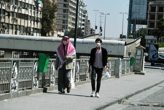 (200329) -- DAMASCUS, March 29, 2020 -- Men are seen wearing masks in Damascus, capital of Syria, on March 28, 2020. Syria has so far registered five coronavirus cases. (Photo by Xinhua) SYRIA-DAMASCUS-COVID-19-FIVE CASES AmmarxSafarjalani 