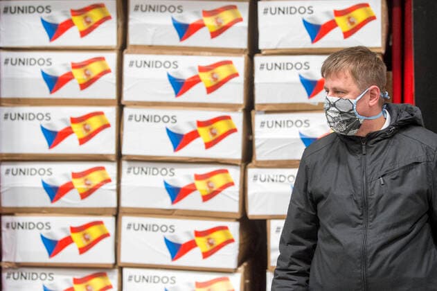 Czech Foreign Affairs Minister Tomas Petricek (Social Democrats, CSSD) prepares boxes with an aid, in Opocinek, Pardubice, Czech Republic, on March 29, 2020. The Czech Republic launched its aid to Spain and Italy, the European countries that are the most afflicted by the novel coronavirus pandemic, sending 20,000 protective suits from the police storage facility in Opocinek to them. (CTKxPhoto JosefxVostarek) CTKPhotoP202003290114601 JVO 003