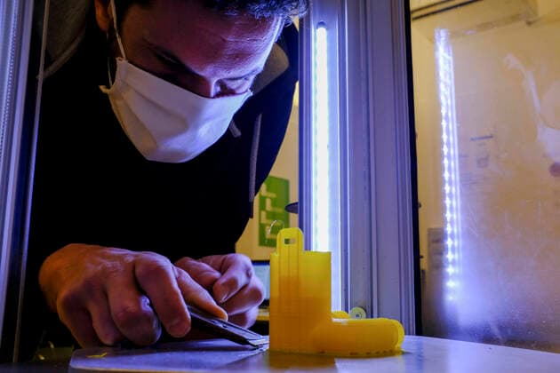 Raniero Madonna removes an adapter from a 3D printer. The adapter can transform a snorkelling mask distributed by Decathlon into an oxygen surgery mask to improve the care for Sars-Cov2 patients seriously ill in Italians hospitals in Remade 3D graphics laboratory that participate to a project made by Isinnova who shared his idea. In Italy hospitals are almost full and more intensive care equipment is needed.  Copyright: xAntonioxBalascox xIPAx xAntonioxBalascox
