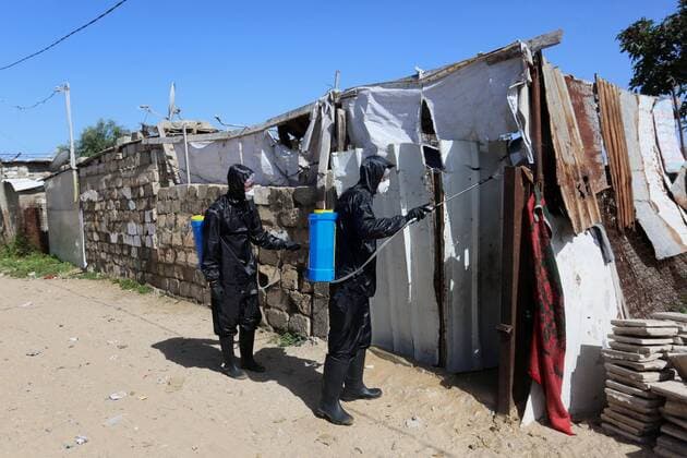 March 29, 2020, Khan Younis, Gaza Strip, Palestinian Territory: Palestinian workers spray disinfectant as a preventive measure amid fears of the spread of the coronavirus at Nahr al-Bared refugee camp in Khan Younis in the southern Gaza Strip on March 29, 2020 Khan Younis Palestinian Territory - ZUMAap3_ 20200329_zaf_ap3_033 Copyright: xAshrafxAmrax