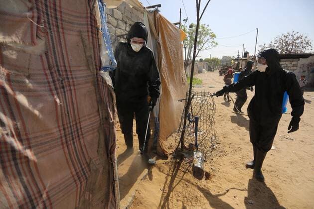 March 29, 2020, Khan Younis, Gaza Strip, Palestinian Territory: Palestinian workers spray disinfectant as a preventive measure amid fears of the spread of the coronavirus at Nahr al-Bared refugee camp in Khan Younis in the southern Gaza Strip on March 29, 2020 Khan Younis Palestinian Territory - ZUMAap3_ 20200329_zaf_ap3_059 Copyright: xAshrafxAmrax