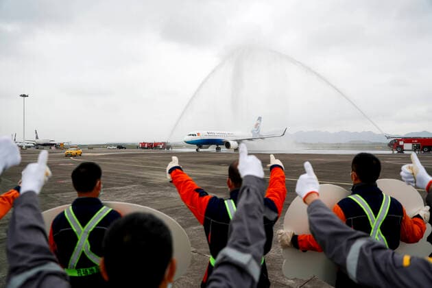 (200329) -- CHONGQING, March 29, 2020 -- An airplane carrying medics supporting virus-hit Hubei Province receives a water cannon salute as it lands at Chongqing Jiangbei International Airport in southwest China s Chongqing, March 29, 2020. The last batch of medical assistance teams from Chongqing, which consists of 313 members, returned from Hubei as the epidemic outbreak in the hard-hit province has been subdued. (Photo by Xinhua) CHINA-CHONGQING-MEDICAL TEAM-RETURN FROM HUBEI (CN) HuangxWei 