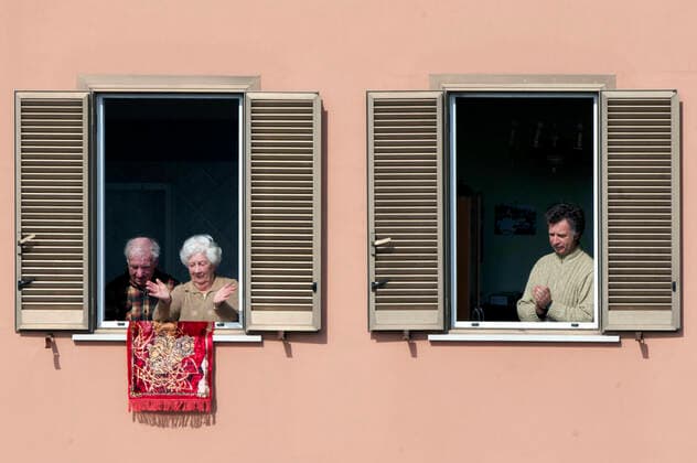 NO FRANCE - NO SWITZERLAND: March 29, 2020 : faithful listens, from the window home, priests celebrating the Sunday Holy Mass from the roof of the church San Gabriele dell Addolorata in Rome  Copyright: x& xa9;AlessiaxGiuliani CPPx xIPAx x& xa9;CatholicxPressxPhotox