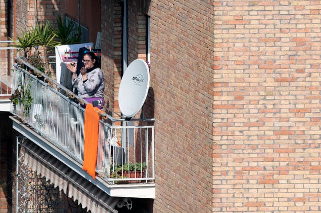 NO FRANCE - NO SWITZERLAND: March 29, 2020 : faithful listens, from the window home, priests celebrating the Sunday Holy Mass from the roof of the church San Gabriele dell Addolorata in Rome  Copyright: x& xa9;AlessiaxGiuliani CPPx xIPAx x& xa9;CatholicxPressxPhotox