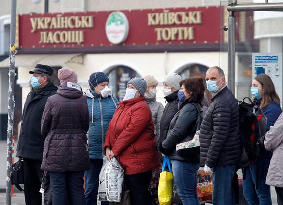 March 29, 2020, Kiev, Ukraine: People wearing protective face masks as a preventive measure against the COVID-19 coronavirus wait at a bus stop after the evacuation..The special train from Kiev to Moscow evacuated Russian citizens to Moscow on 27 March 2020, and brought back Ukrainian citizens from Moscow to Kiev on 29 March 2020, after Ukrainian authorities shut the country s borders amid the spread of the COVID-19 coronavirus pandemic. Kiev Ukraine - ZUMAs197 20200329_zaa_s197_049 Copyright: xPavloxGoncharx