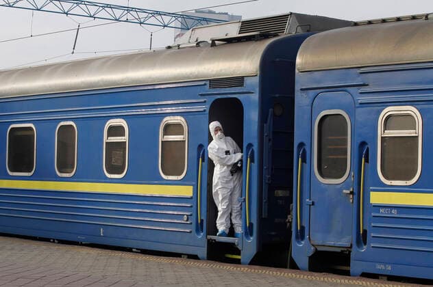 March 29, 2020, Kiev, Ukraine: Ukrainian border guard officer wearing a protective suit as a preventive measure, standing inside a train with Ukrainian citizens after the evacuation..The special train from Kiev to Moscow evacuated Russian citizens to Moscow on 27 March 2020, and brought back Ukrainian citizens from Moscow to Kiev on 29 March 2020, after Ukrainian authorities shut the country s borders amid the spread of the COVID-19 coronavirus pandemic. Kiev Ukraine - ZUMAs197 20200329_zaa_s197_057 Copyright: xPavloxGoncharx