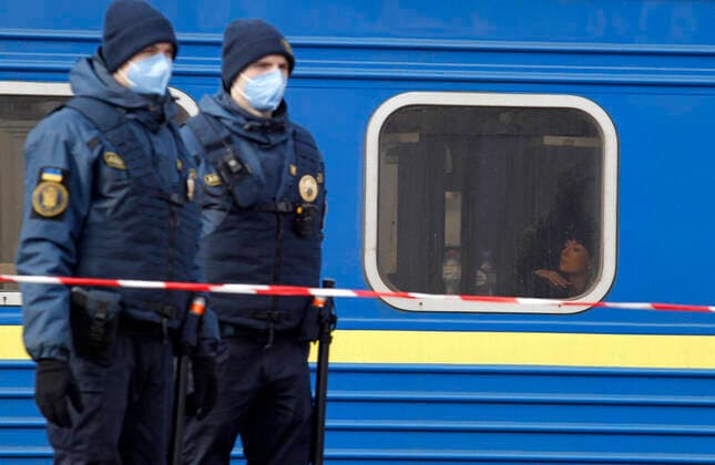 March 29, 2020, Kiev, Ukraine: Ukrainian police officers wearing protective masks as a preventive measure, stand next to a train after the evacuation..The special train from Kiev to Moscow evacuated Russian citizens to Moscow on 27 March 2020, and brought back Ukrainian citizens from Moscow to Kiev on 29 March 2020, after Ukrainian authorities shut the country s borders amid the spread of the COVID-19 coronavirus pandemic. Kiev Ukraine - ZUMAs197 20200329_zaa_s197_065 Copyright: xPavloxGoncharx