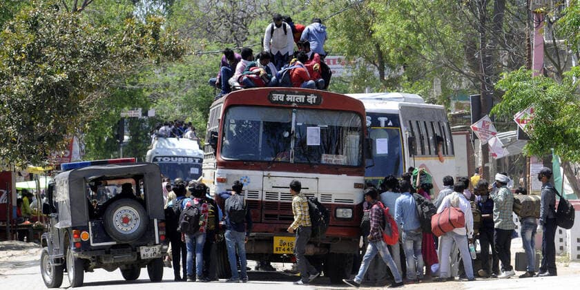 LUCKNOW, INDIA - MARCH 29: Migrant workers try to board an overcrowded bus to return to their home on Day 5 of the 21 day nationwide lockdown imposed by PM Narendra Modi to curb the spread of coronavirus, at Asti Road, Bakshi Ka Talab, on March 29, 2020 in Lucknow, India. (Photo by Dheeraj Dhawan Hindustan Times ) Migrant Workers Head Home In Coronavirus Lockdown