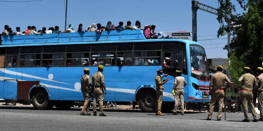 LUCKNOW, INDIA - MARCH 29: Police personnel administer buses carrying migrant workers as they make their return home on Day 5 of the 21 day nationwide lockdown imposed by PM Narendra Modi to curb the spread of coronavirus, at Asti Road, Bakshi Ka Talab, on March 29, 2020 in Lucknow, India. (Photo by Dheeraj Dhawan Hindustan Times ) Migrant Workers Head Home In Coronavirus Lockdown