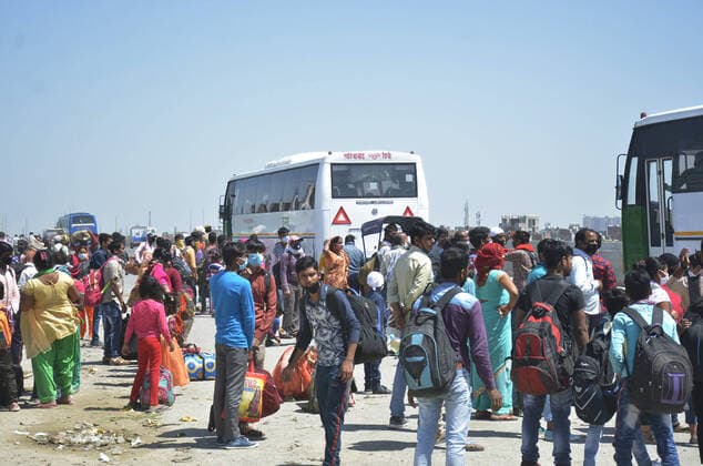 GHAZIABAD, INDIA - MARCH 29: A huge gathering of migrant workers seen at NH9 road near Vijay Nagar on Day 5 of the 21 day nationwide lockdown imposed by PM Narendra Modi to curb the spread of coronavirus, on March 29, 2020 in Ghaziabad, India. (Photo by Sakib Ali Hindustan Times ) Migrant Workers Head Home In Coronavirus Lockdown