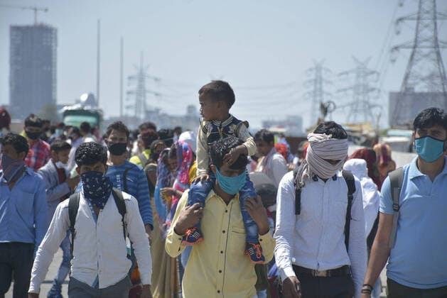 GHAZIABAD, INDIA - MARCH 29: Migrant workers head home on Day 5 of the 21 day nationwide lockdown imposed by PM Narendra Modi to curb the spread of coronavirus, at NH9 road, near Vijay Nagar, on March 29, 2020 in Ghaziabad, India. (Photo by Sakib Ali Hindustan Times ) Migrant Workers Head Home In Coronavirus Lockdown