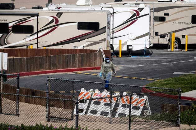 March 29, 2020, Los Angeles, California, U.S: A worker walks in RV s park at Dockweiler State Beach, in an area being used as an isolation zone for those who cannot self-isolate and are being asked to quarantine by the Los Angeles County Department of Health, amid the coronavirus pandemic on Sunday March 29, 2020 in Los Angeles, California. Los Angeles U.S. - ZUMAc68_ 20200329_zaf_c68_003 Copyright: xRingoxChiux