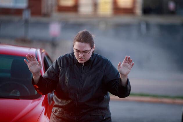 March 29, 2020, Bloomington, Indiana, United States: A community member from the Lighthouse Fellowship Church gather on a Sunday night outside the Bloomington Hospital to pray for doctors, nursing staff, and other workers, who are caring for patients, including some of the 22 people in Monroe County confirmed to have been sickened by COVID-19 Coronavirus..A similar prayer took place yesterday in the state of Georgia. Bloomington United States - ZUMAs197 20200329_zaa_s197_155 Copyright: xJeremyxHoganx