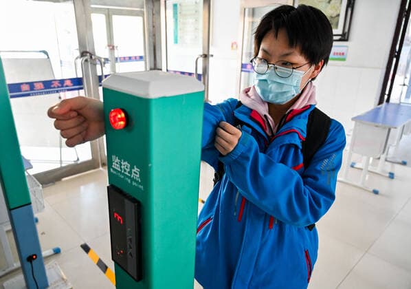 (200330) -- HOHHOT, March 30, 2020 -- A graduating student gets temperature checked at the entrance of the school building of Hohhot No. 35 Middle School in Hohhot, north China s Inner Mongolia Autonomous Region, March 30, 2020. Students in their final year of senior and junior high schools in Inner Mongolia returned to school and embraced their new spring semester on Monday. ) CHINA-INNER MONGOLIA-SCHOOL REOPENING (CN) LianxZhen 