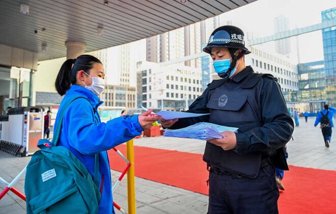 (200330) -- HOHHOT, March 30, 2020 -- A school staff member collects the health information form of a student at Hohhot No. 35 Middle School in Hohhot, north China s Inner Mongolia Autonomous Region, March 30, 2020. Students in their final year of senior and junior high schools in Inner Mongolia returned to school and embraced their new spring semester on Monday. ) CHINA-INNER MONGOLIA-SCHOOL REOPENING (CN) LianxZhen 