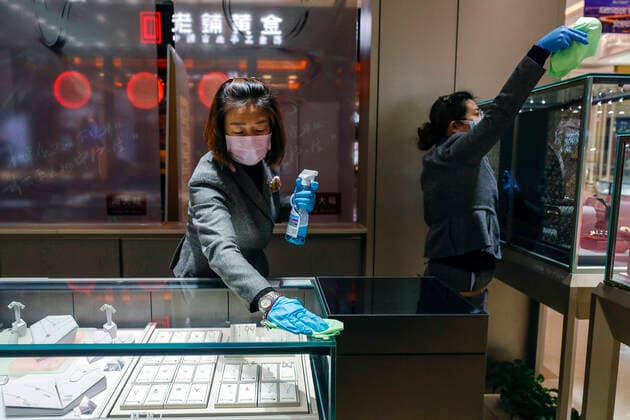 (200330) -- WUHAN, March 30, 2020 -- Staff members clean the counter at a shopping mall in Wuhan, central China s Hubei Province, March 30, 2020. Many shopping malls in Wuhan reopened on Monday. ) CHINA-WUHAN-SHOPPING MALL-REOPENING (CN) ShenxBohan 