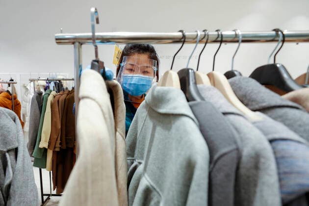 (200330) -- WUHAN, March 30, 2020 -- A sales clerk arranges clothes at a shopping mall in Wuhan, central China s Hubei Province, March 30, 2020. Many shopping malls in Wuhan reopened on Monday. ) CHINA-WUHAN-SHOPPING MALL-REOPENING (CN) ShenxBohan 