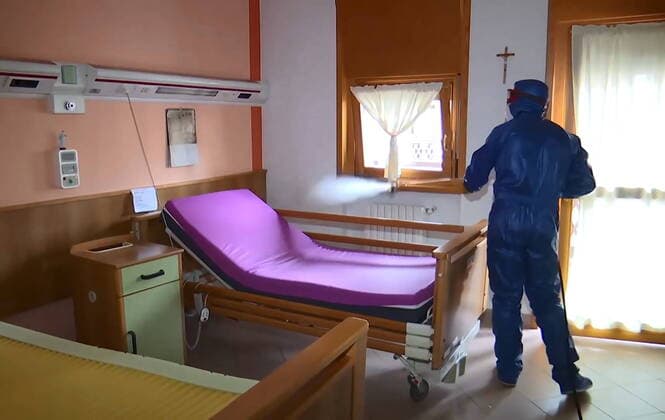 LOMBARDY, ITALY - MARCH 30, 2020: A brigade of Russian epidemiologists and experts of the Troops of Radiological, Chemical and Biological Defence of the Russian Defence Ministry together with Italian military specialists carry out a full disinfection of the Casa Serena residence for senior citizens in the town of Leffe, the province of Bergamo. Video screen grab. Russian Defence Ministry TASS  TS0D3D8B