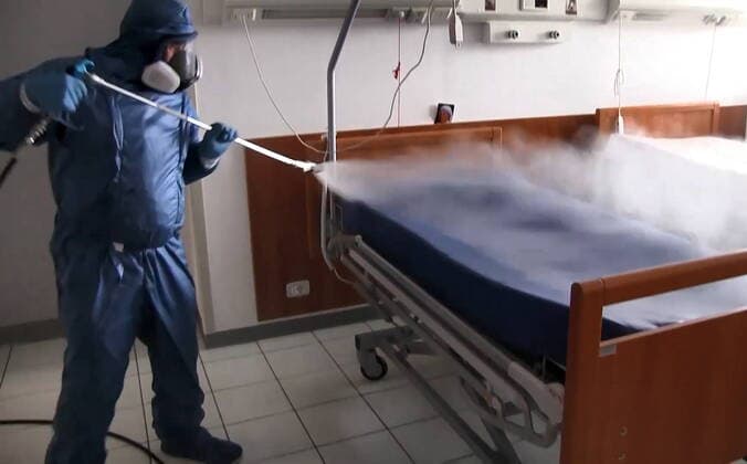LOMBARDY, ITALY - MARCH 30, 2020: A brigade of Russian epidemiologists and experts of the Troops of Radiological, Chemical and Biological Defence of the Russian Defence Ministry together with Italian military specialists carry out a full disinfection of the Casa Serena residence for senior citizens in the town of Leffe, the province of Bergamo. Video screen grab. Russian Defence Ministry TASS  TS0D3D9A