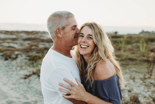 Married couple embracing at beach during sunset San Diego, CA, United States ,model released, Symbolfoto CR_KESM200304B-212558-01
