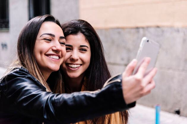 Beautiful Lesbian Couple Taking A Self Portrait At The Street. LGBT. Madrid, Community of Madrid, Spain ,model released, Symbolfoto CR_DAES200306-320636-01