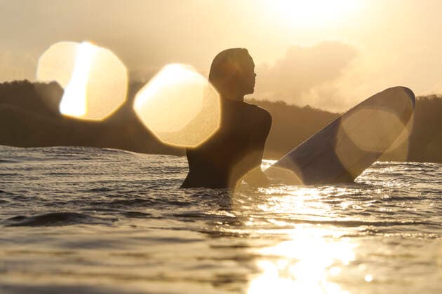 Female surfer in the ocean at sunset Lombok, Nusa Tenggara Bar., Indonesia ,model released, Symbolfoto CR_KOTRIN200312D-290307-01
