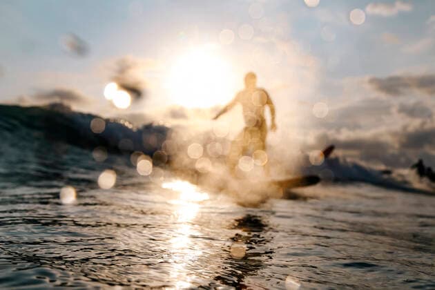 Surfer on a wave at sunset time Lombok, Nusa Tenggara Bar., Indonesia CR_KOTRIN200312O-290380-01