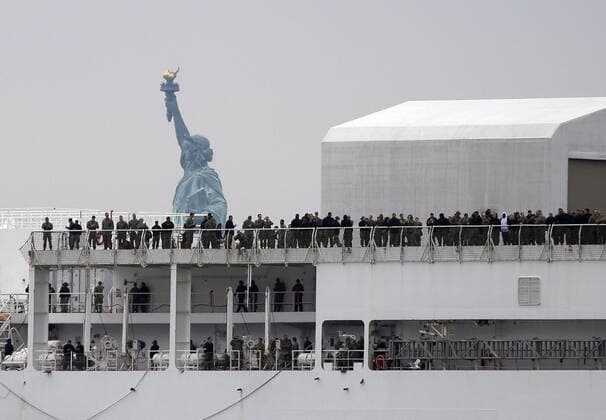 The USNS Comfort Navy ship moves past the Statue Of Liberty on route to dock at Pier 90 in the Hudson River in New York City on Monday March 30, 2020. The floating hospital in the form of a Navy ship will arrive in New York City on Monday to relieve pressure on hospitals already overwhelmed with coronavirus patients. The USNS Comfort is set to dock around 10 a.m. and it will be ready to take in patients within 24 hours.  NYP20200330107 JOHNxANGELILLO