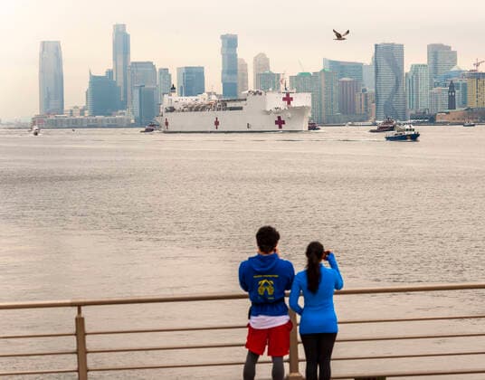 New York during the COVID-19 pandemic Visitors to Hudson River Park in New York greet the USNS Comfort hospital ship as it arrives in New York on Monday, March 30, 2020. The ship will berth at Pier 90 and use its 1,000 hospital beds to serve non-COVID-19 patients taken some of the burden off of New York hospitals. (  RichardxB.xLevine