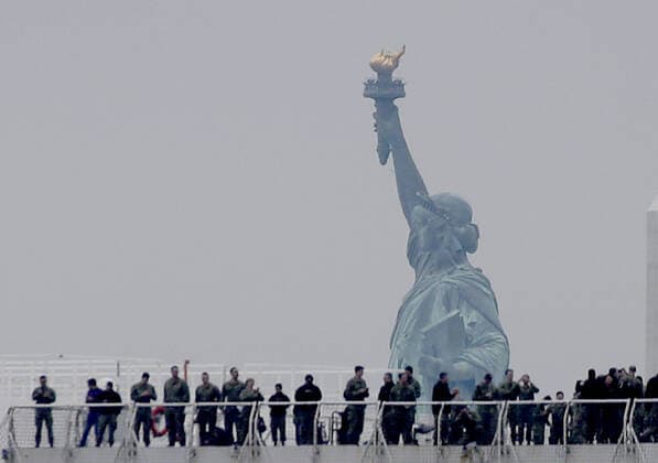 The USNS Comfort Navy ship moves past the Statue Of Liberty on route to dock at Pier 90 in the Hudson River in New York City on Monday March 30, 2020. The floating hospital in the form of a Navy ship will arrive in New York City on Monday to relieve pressure on hospitals already overwhelmed with coronavirus patients. The USNS Comfort is set to dock around 10 a.m. and it will be ready to take in patients within 24 hours.  NYP20200330113 JOHNxANGELILLO