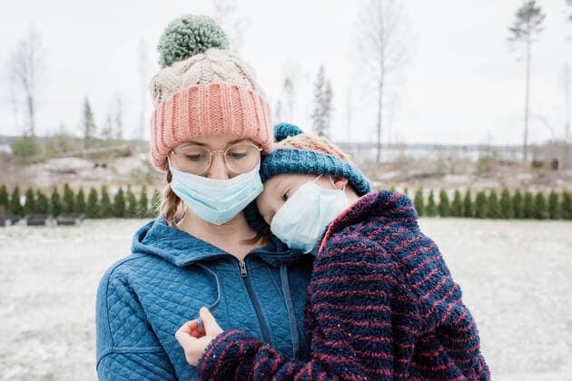 mother carrying son with face masks on for protection from virus & flu NorrtoÂ¤lje, Stockholm County, Sweden ,model released, Symbolfoto CR_RABE200313B-319707-01