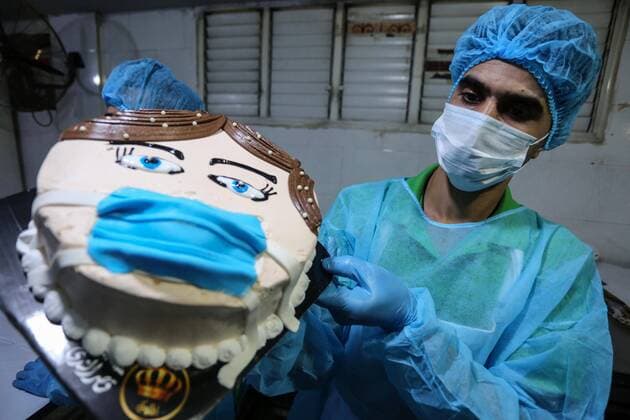 March 30, 2020, Khan Yunis, Gaza Strip, Palestinian Territory: Palestinians put final touches on cakes that portrays a woman wearing a facemask, at their shop in Khan Yunis in the southern Gaza Strip on March 30, 2020. The United Nations has warned that a COVID-19 outbreak in Gaza could be disastrous, given the high poverty rates and weak health system in the coastal strip under Israeli blockade since 2007. Authorities in Gaza have said that more than 2,700 Palestinians are in home-isolation, mostly people who had returned from Egypt Khan Yunis Palestinian Territory - ZUMAap3_ 20200330_zaf_ap3_135 Copyright: xAshrafxAmrax