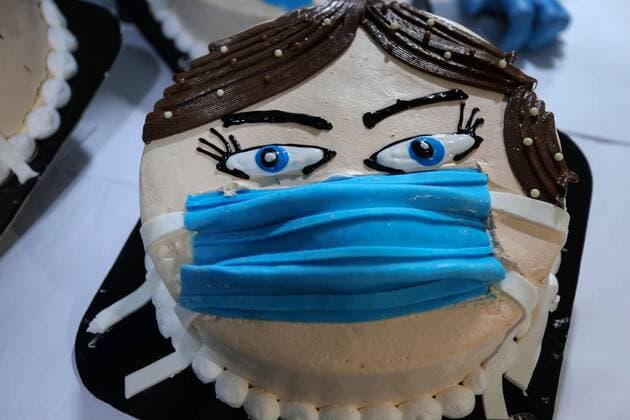 March 30, 2020, Khan Yunis, Gaza Strip, Palestinian Territory: Palestinians put final touches on cakes that portrays a woman wearing a facemask, at their shop in Khan Yunis in the southern Gaza Strip on March 30, 2020. The United Nations has warned that a COVID-19 outbreak in Gaza could be disastrous, given the high poverty rates and weak health system in the coastal strip under Israeli blockade since 2007. Authorities in Gaza have said that more than 2,700 Palestinians are in home-isolation, mostly people who had returned from Egypt Khan Yunis Palestinian Territory - ZUMAap3_ 20200330_zaf_ap3_137 Copyright: xAshrafxAmrax