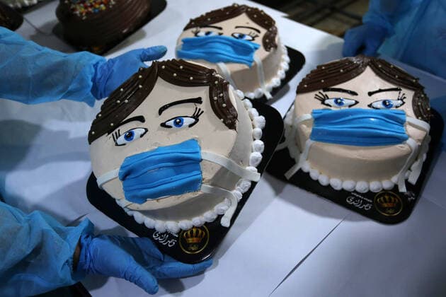 March 30, 2020, Khan Yunis, Gaza Strip, Palestinian Territory: Palestinians put final touches on cakes that portrays a woman wearing a facemask, at their shop in Khan Yunis in the southern Gaza Strip on March 30, 2020. The United Nations has warned that a COVID-19 outbreak in Gaza could be disastrous, given the high poverty rates and weak health system in the coastal strip under Israeli blockade since 2007. Authorities in Gaza have said that more than 2,700 Palestinians are in home-isolation, mostly people who had returned from Egypt Khan Yunis Palestinian Territory - ZUMAap3_ 20200330_zaf_ap3_144 Copyright: xAshrafxAmrax