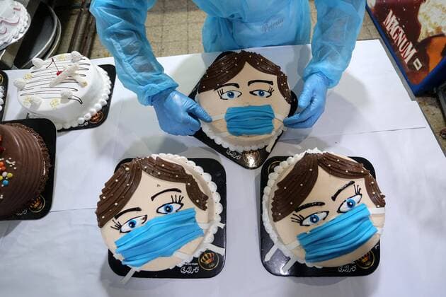 March 30, 2020, Khan Yunis, Gaza Strip, Palestinian Territory: Palestinians put final touches on cakes that portrays a woman wearing a facemask, at their shop in Khan Yunis in the southern Gaza Strip on March 30, 2020. The United Nations has warned that a COVID-19 outbreak in Gaza could be disastrous, given the high poverty rates and weak health system in the coastal strip under Israeli blockade since 2007. Authorities in Gaza have said that more than 2,700 Palestinians are in home-isolation, mostly people who had returned from Egypt Khan Yunis Palestinian Territory - ZUMAap3_ 20200330_zaf_ap3_148 Copyright: xAshrafxAmrax