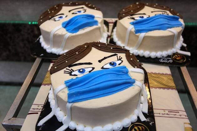 March 30, 2020, Khan Yunis, Gaza Strip, Palestinian Territory: Palestinians put final touches on cakes that portrays a woman wearing a facemask, at their shop in Khan Yunis in the southern Gaza Strip on March 30, 2020. The United Nations has warned that a COVID-19 outbreak in Gaza could be disastrous, given the high poverty rates and weak health system in the coastal strip under Israeli blockade since 2007. Authorities in Gaza have said that more than 2,700 Palestinians are in home-isolation, mostly people who had returned from Egypt Khan Yunis Palestinian Territory - ZUMAap3_ 20200330_zaf_ap3_151 Copyright: xAshrafxAmrax