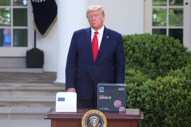 March 30, 2020, Washington, District of Columbia, USA: US President Donald J. Trump stands with the Abbot ID NOW COVID-19 test box during the Coronavirus Task Force press briefing on the coronavirus and COVID-19 pandemic, in the Rose Garden at the White House, in Washington, DC, USA, 30 March 2020 Washington USA - ZUMAs152 20200330_zaa_s152_017 Copyright: xMichaelxReynoldsx