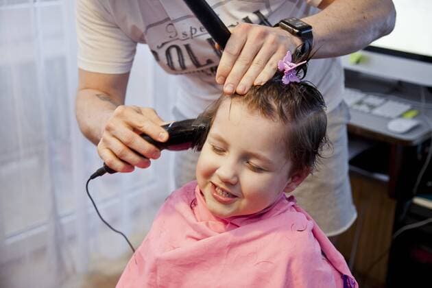 A boy gets a home haircut by his father during the coronavirus outbreak A young boy gets a haircut by his father at home on March 30, 2020 in Warsaw, Poland as all the hairdresser s have been closed due to the coronavirus outbreak. EN_01422502_0006 
