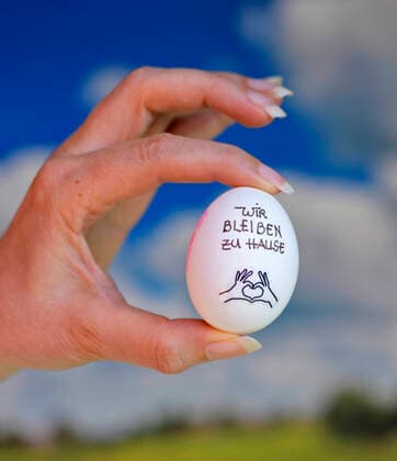 31.03.2020, Symbolbild: Slogan Wir bleiben zu Hause auf einem Hühnerei. Ein Slogan wegen der Corona-Krisen-Ausgangsbeschränkung in Deutschland. 31.03.2020, Ei mit Corona-Slogan 31.03.2020, Ei mit Corona-Slogan