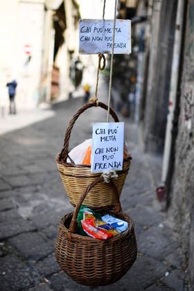 A solidarity basket with a note reading Who can may put, who cannot may take is displayed in one of the deserted streets in the historic center of Naples, southern Italy.After a government decree declaring all of Italy a protected area to combat covid -19 coronavirus infection.  Copyright: xSalvatorexLaportax xIPAx xKontrolabx