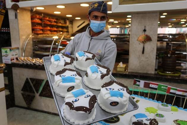 March 31, 2020, Khan Yunis, Gaza Strip, Palestinian Territory: Palestinians put final touches on cakes that portrays a woman wearing a facemask with model of bottel of Dettol to sterilize, at their shop in Khan Yunis in the southern Gaza Strip on March 31, 2020. The United Nations has warned that a COVID-19 outbreak in Gaza could be disastrous, given the high poverty rates and weak health system in the coastal strip under Israeli blockade since 2007. Authorities in Gaza have said that more than 2,700 Palestinians are in home-isolation, mostly people who had returned from Egypt Khan Yunis Palestinian Territory - ZUMAap3_ 20200331_zaf_ap3_103 Copyright: xAshrafxAmrax